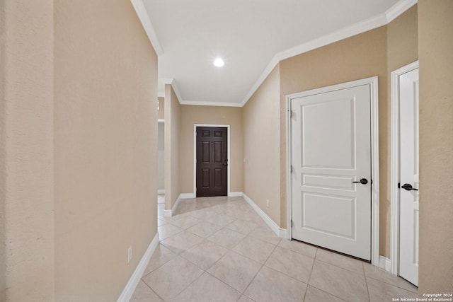 hallway with light tile patterned floors and crown molding