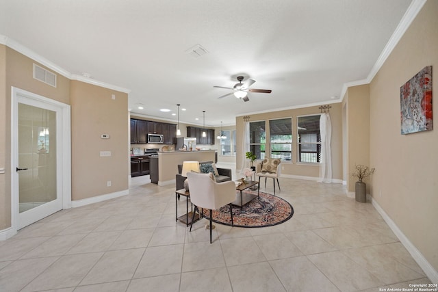 dining room with ceiling fan, ornamental molding, and light tile patterned floors