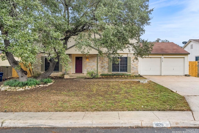 view of front of property featuring a garage and a front yard