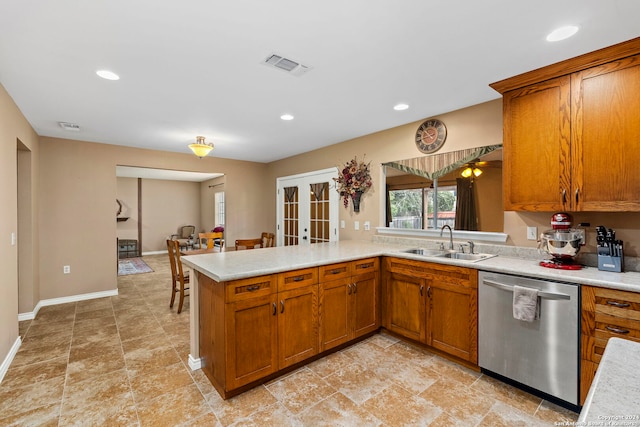 kitchen featuring kitchen peninsula, dishwasher, french doors, and sink