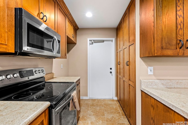 kitchen featuring light stone countertops and appliances with stainless steel finishes