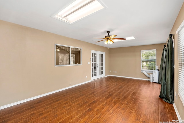 empty room featuring ceiling fan, french doors, and hardwood / wood-style flooring