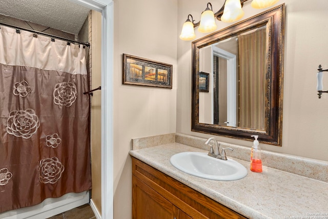 bathroom featuring vanity, a textured ceiling, and shower / tub combo with curtain