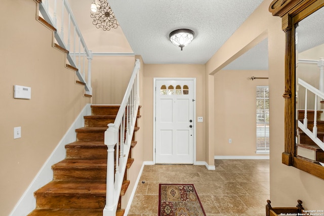 foyer with a textured ceiling