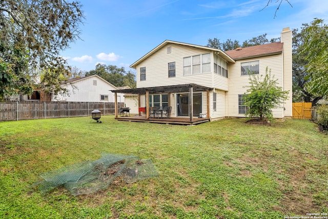 rear view of property featuring a wooden deck and a yard