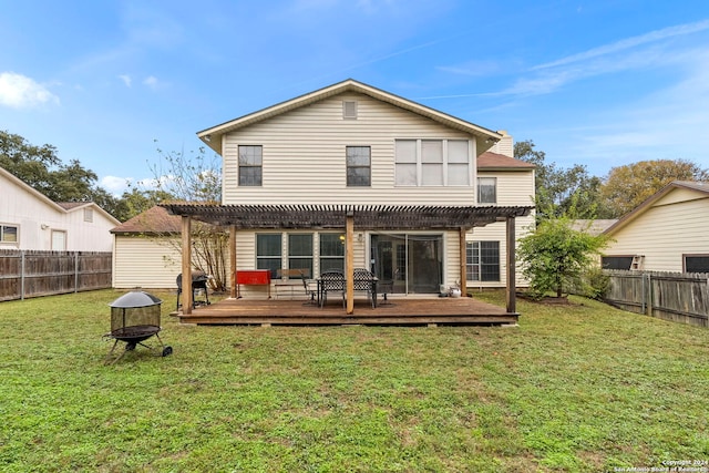 back of house featuring a yard, a pergola, a fire pit, and a wooden deck