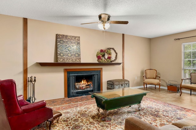 living room with ceiling fan and a textured ceiling