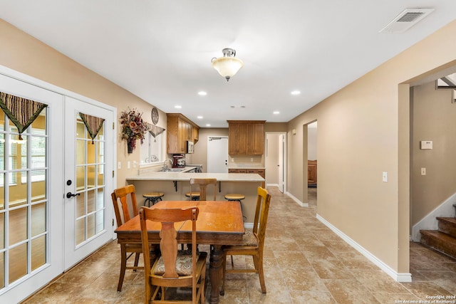 dining area featuring french doors and sink