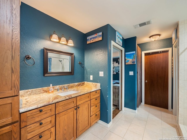 bathroom featuring tile patterned flooring and vanity