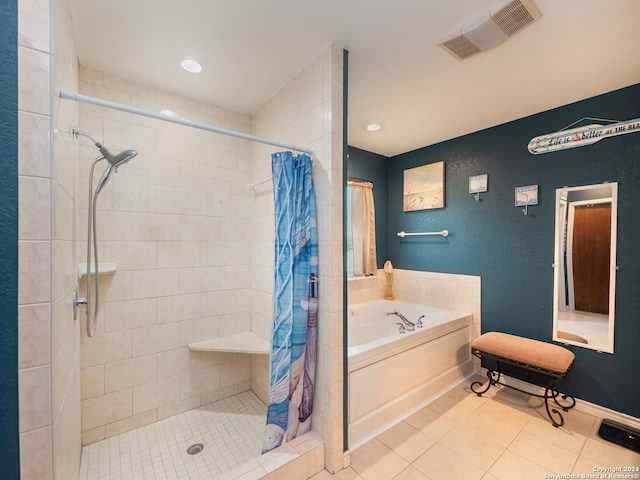 bathroom with tile patterned flooring and separate shower and tub