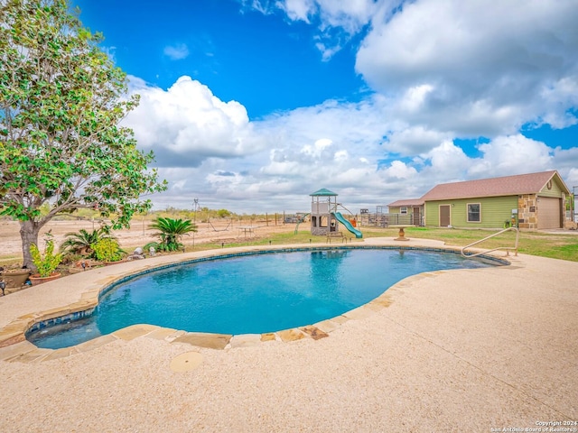 view of pool with a patio and a water slide