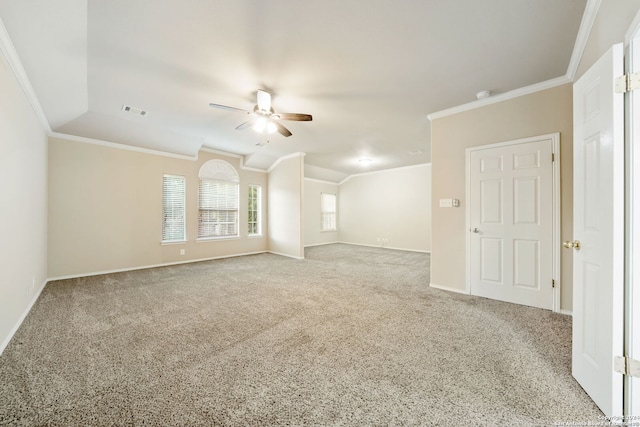 carpeted empty room with vaulted ceiling, ceiling fan, and crown molding