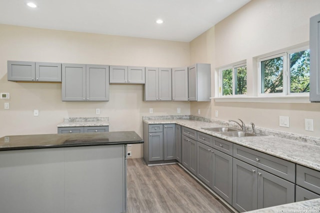 kitchen featuring gray cabinets, sink, and hardwood / wood-style flooring