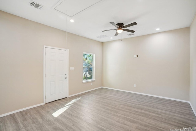 spare room featuring wood-type flooring and ceiling fan