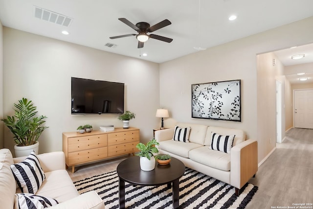 living room featuring ceiling fan and light hardwood / wood-style floors