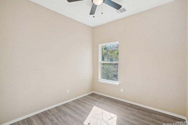 unfurnished room with ceiling fan and hardwood / wood-style flooring