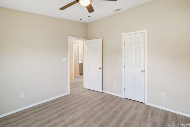 unfurnished bedroom with light wood-type flooring and ceiling fan