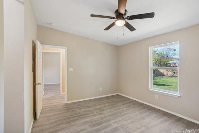 spare room featuring ceiling fan and light hardwood / wood-style flooring