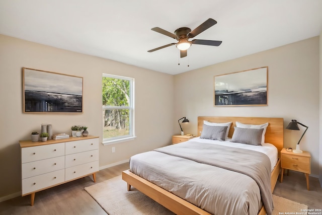 bedroom with ceiling fan and light wood-type flooring