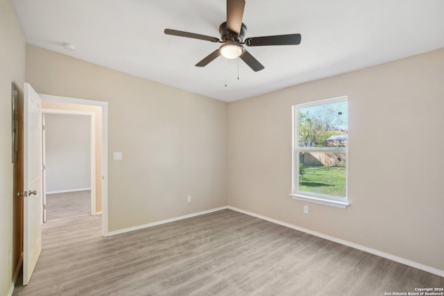 empty room featuring ceiling fan and light wood-type flooring