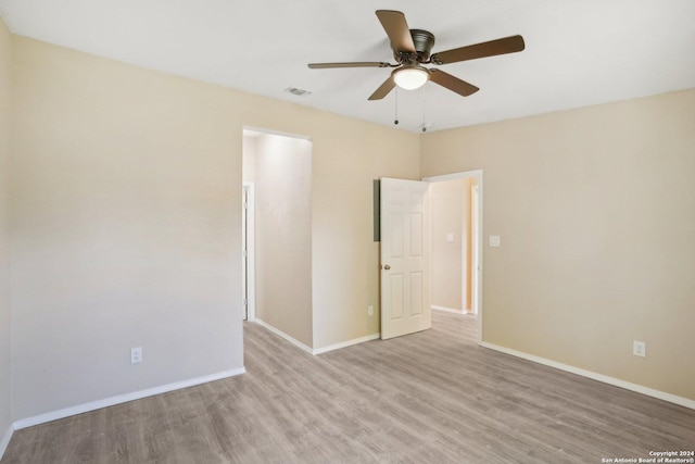 empty room with light hardwood / wood-style floors and ceiling fan