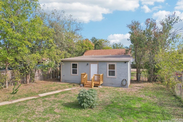 back of house with a lawn