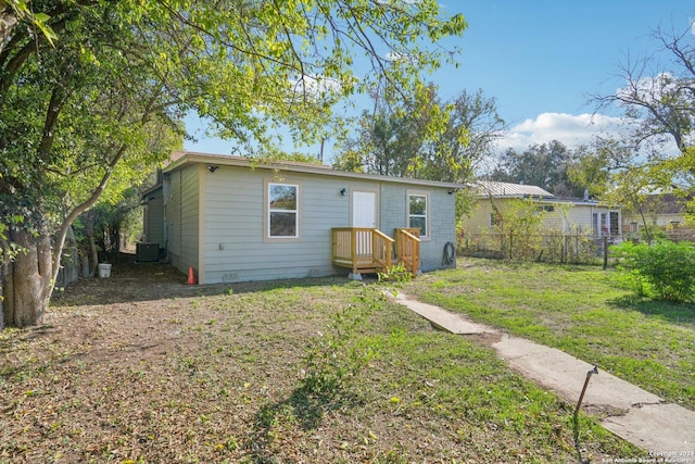 view of front facade with a front yard and central AC unit