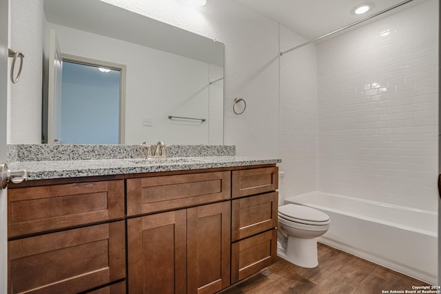 full bathroom featuring vanity, toilet, wood-type flooring, and tub / shower combination