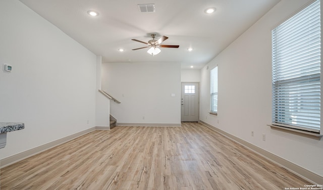 unfurnished room with ceiling fan and light hardwood / wood-style floors