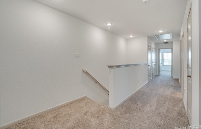 hallway with light colored carpet