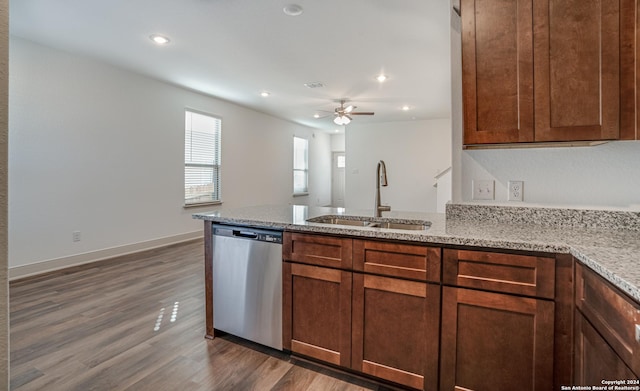 kitchen featuring ceiling fan, sink, light stone counters, stainless steel dishwasher, and dark hardwood / wood-style floors