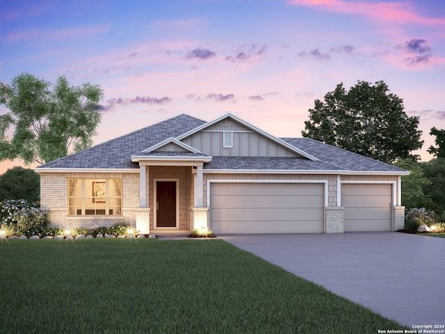 craftsman-style home featuring an attached garage, board and batten siding, concrete driveway, and brick siding