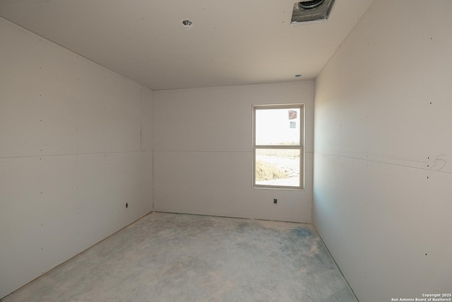 spare room with unfinished concrete floors