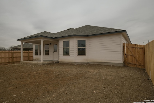 rear view of property with a patio and a fenced backyard