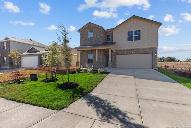 view of front of home with brick siding, fence, a garage, driveway, and a front lawn