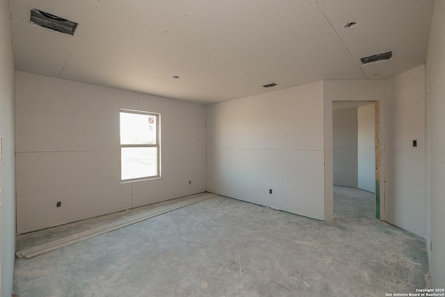 unfurnished room featuring visible vents and unfinished concrete floors