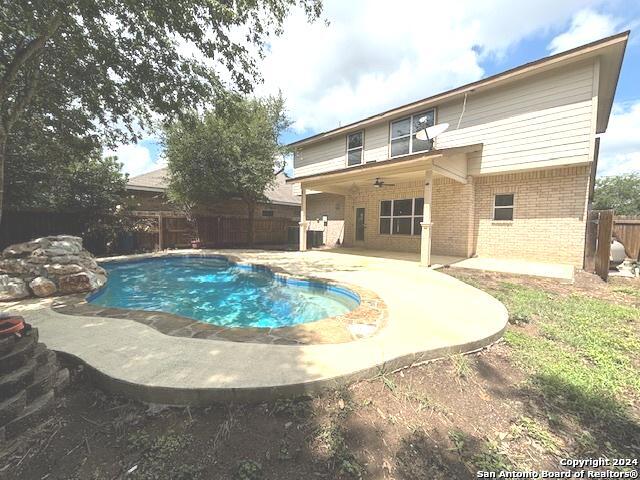 view of swimming pool with ceiling fan and a patio