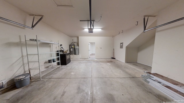 garage featuring electric panel and water heater