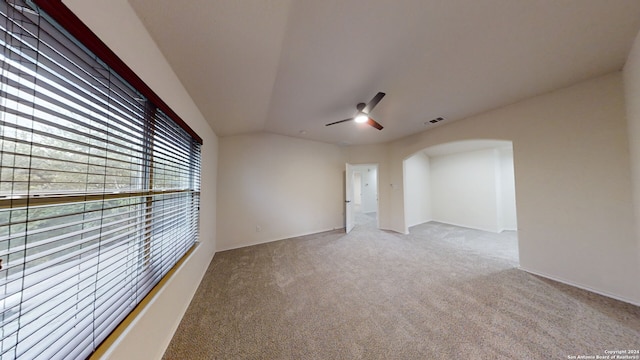 empty room featuring carpet, ceiling fan, and lofted ceiling