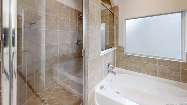 bathroom with shower with separate bathtub