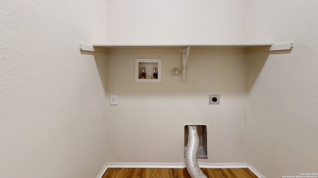 laundry area featuring washer hookup, hardwood / wood-style flooring, gas dryer hookup, and electric dryer hookup