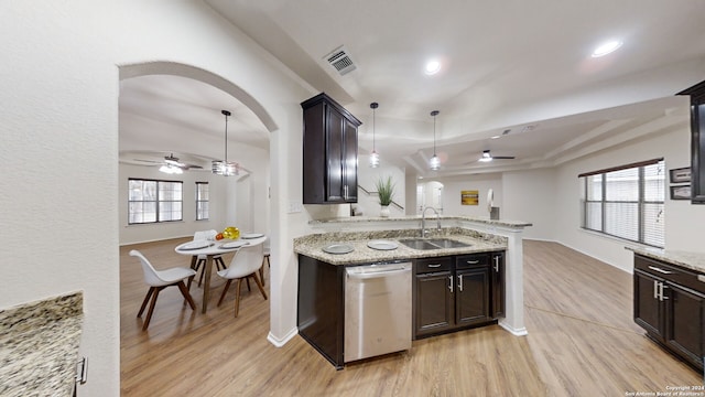 kitchen with dishwasher, light wood-type flooring, decorative light fixtures, and sink