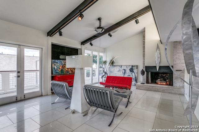 interior space with ceiling fan, a healthy amount of sunlight, light tile patterned floors, and french doors