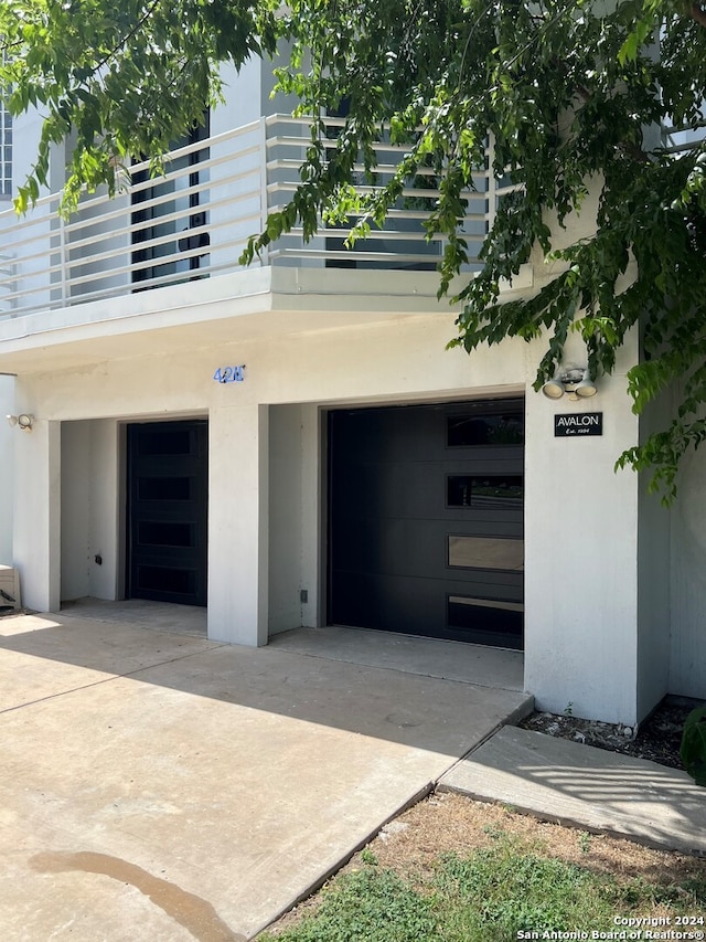 property entrance with a balcony and a garage