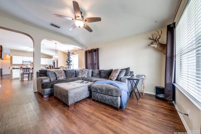 living room featuring ceiling fan, dark wood-type flooring, and lofted ceiling