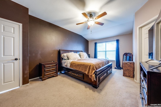 bedroom with light colored carpet, ceiling fan, and lofted ceiling