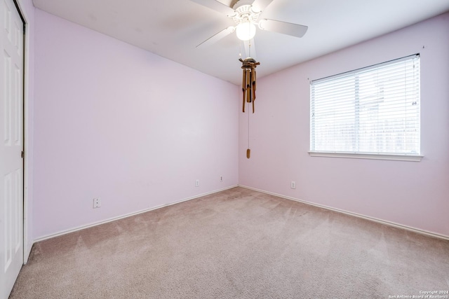 carpeted empty room with ceiling fan