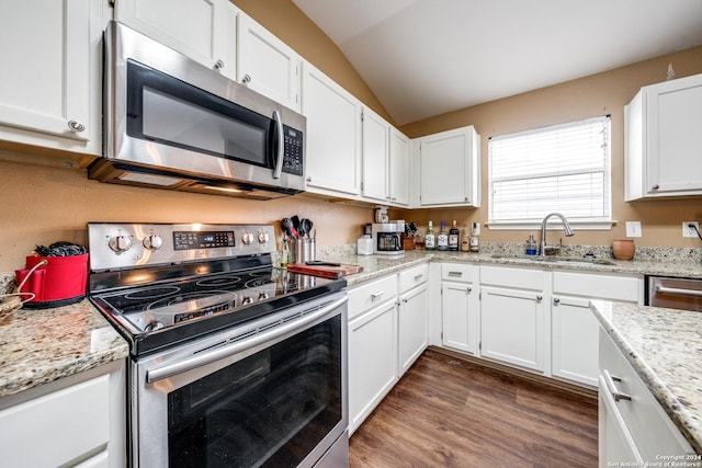 kitchen featuring white cabinetry, sink, dark hardwood / wood-style floors, vaulted ceiling, and appliances with stainless steel finishes