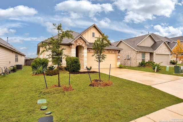 craftsman inspired home featuring cooling unit, a garage, and a front lawn