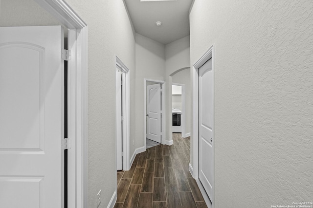 corridor with dark hardwood / wood-style floors